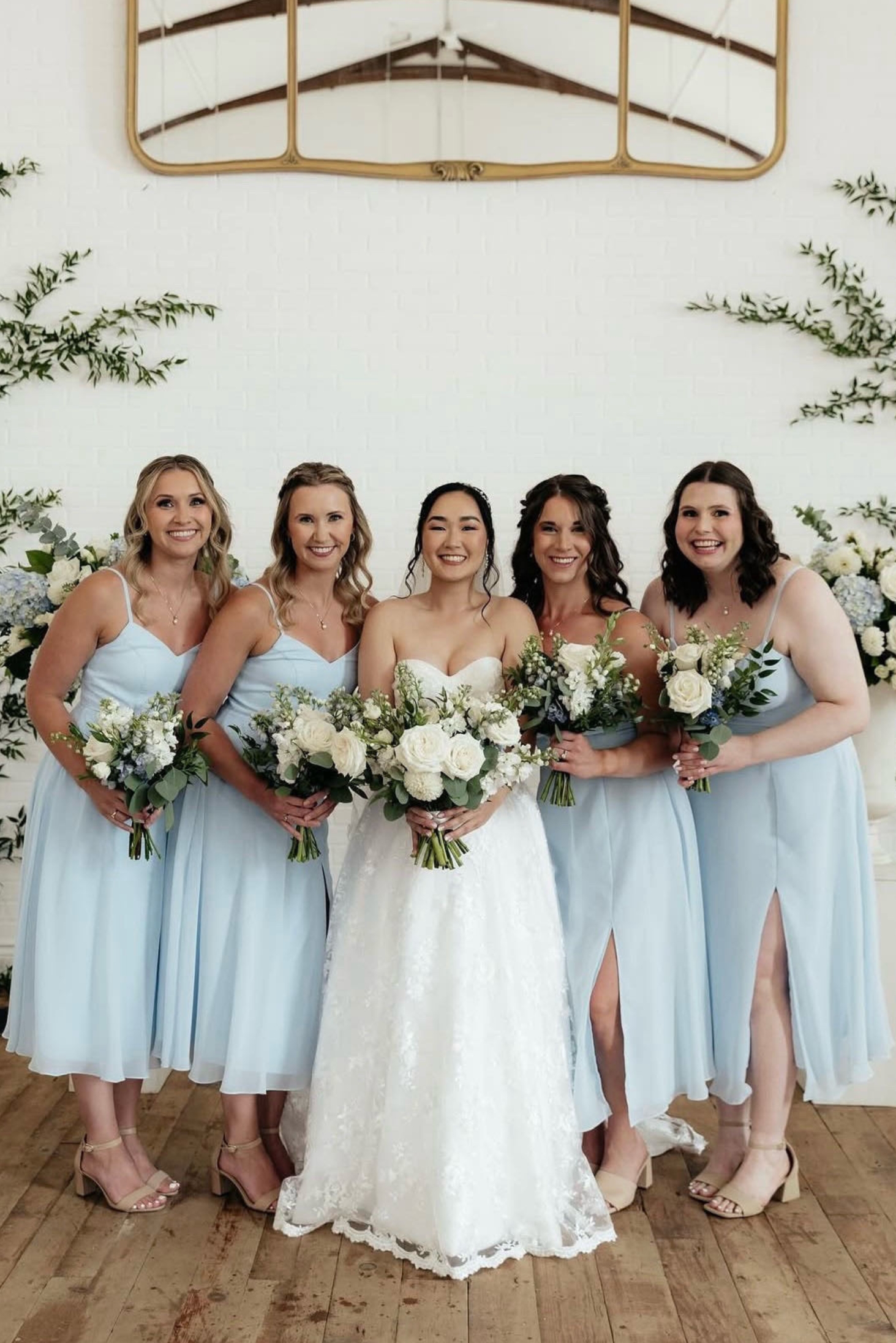 Bride with bridesmaids in light blue dresses